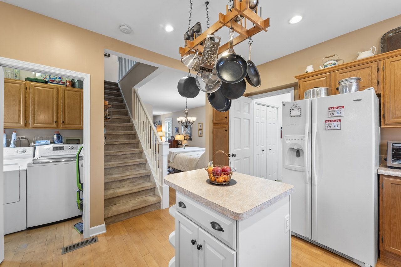 114 South Elm Street Mount Prospect, IL 60056 - Photo 18 of 44 a kitchen with a refrigerator a sink and chandelier