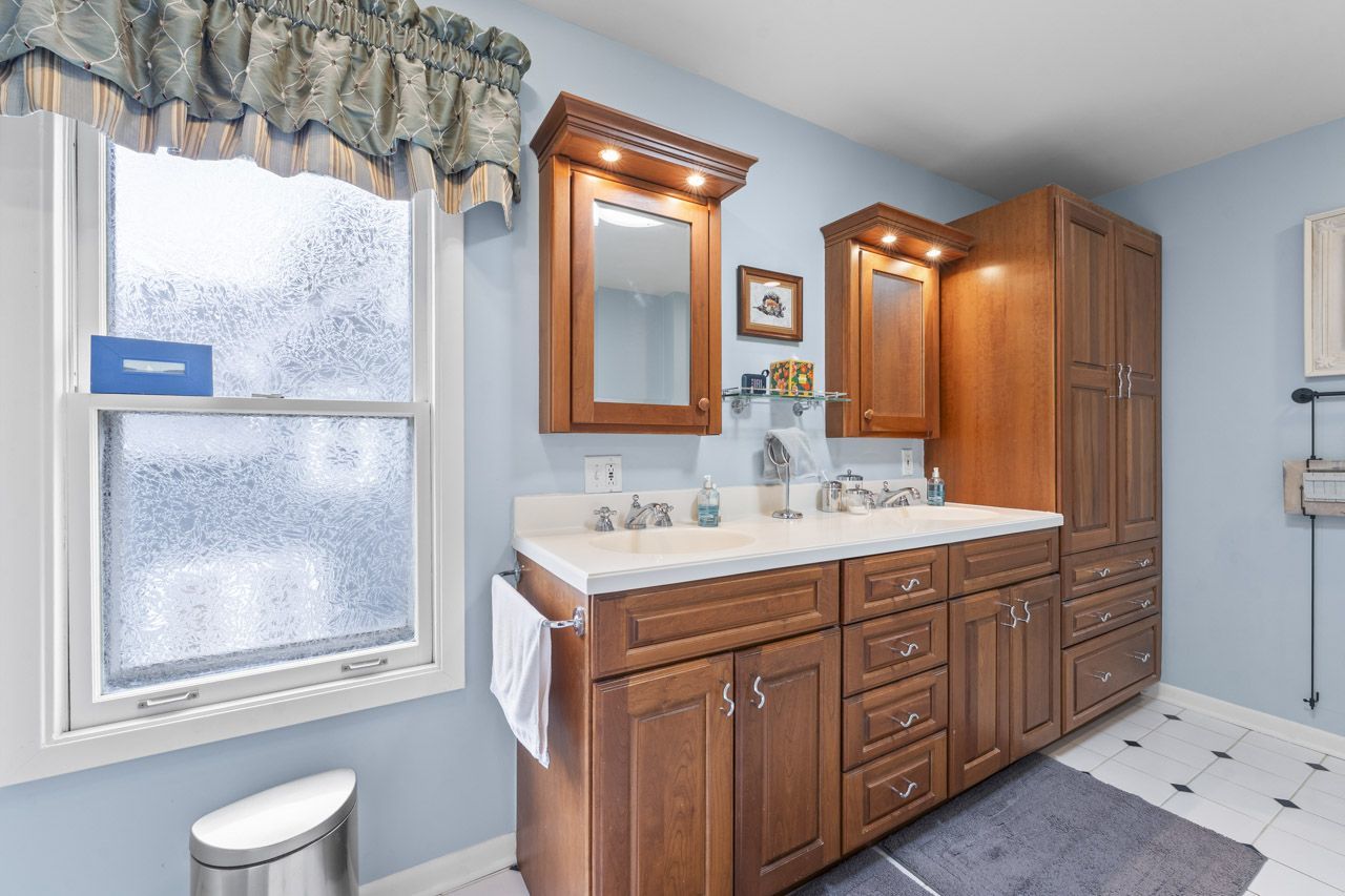 114 South Elm Street Mount Prospect, IL 60056 - Photo 29 of 44 a bathroom with a sink a toilet and a mirror