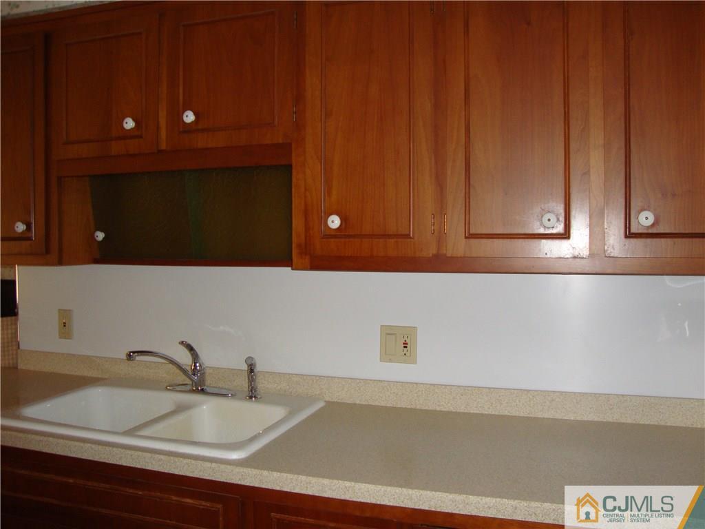 231 Davidson's Mill Road North Brunswick, NJ 08902 - Photo 3 of 17 a bathroom with a sink and cabinets