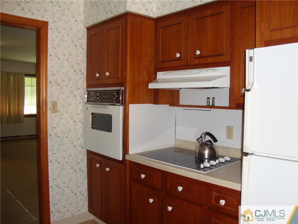 231 Davidson's Mill Road North Brunswick, NJ 08902 - Photo 4 of 17 a kitchen with a refrigerator and cabinets