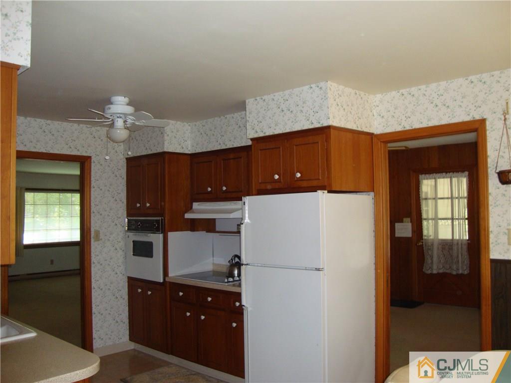 231 Davidson's Mill Road North Brunswick, NJ 08902 - Photo 5 of 17 a kitchen with a refrigerator and a chandelier