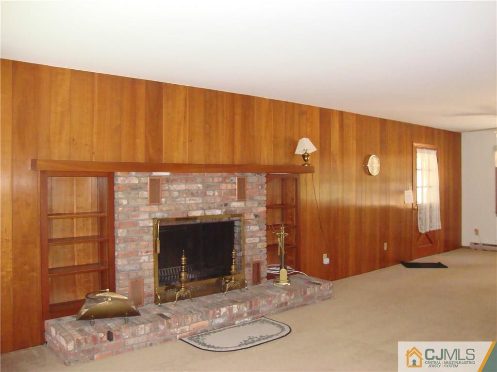 231 Davidson's Mill Road North Brunswick, NJ 08902 - Photo 7 of 17 a kitchen with a fireplace and a chair