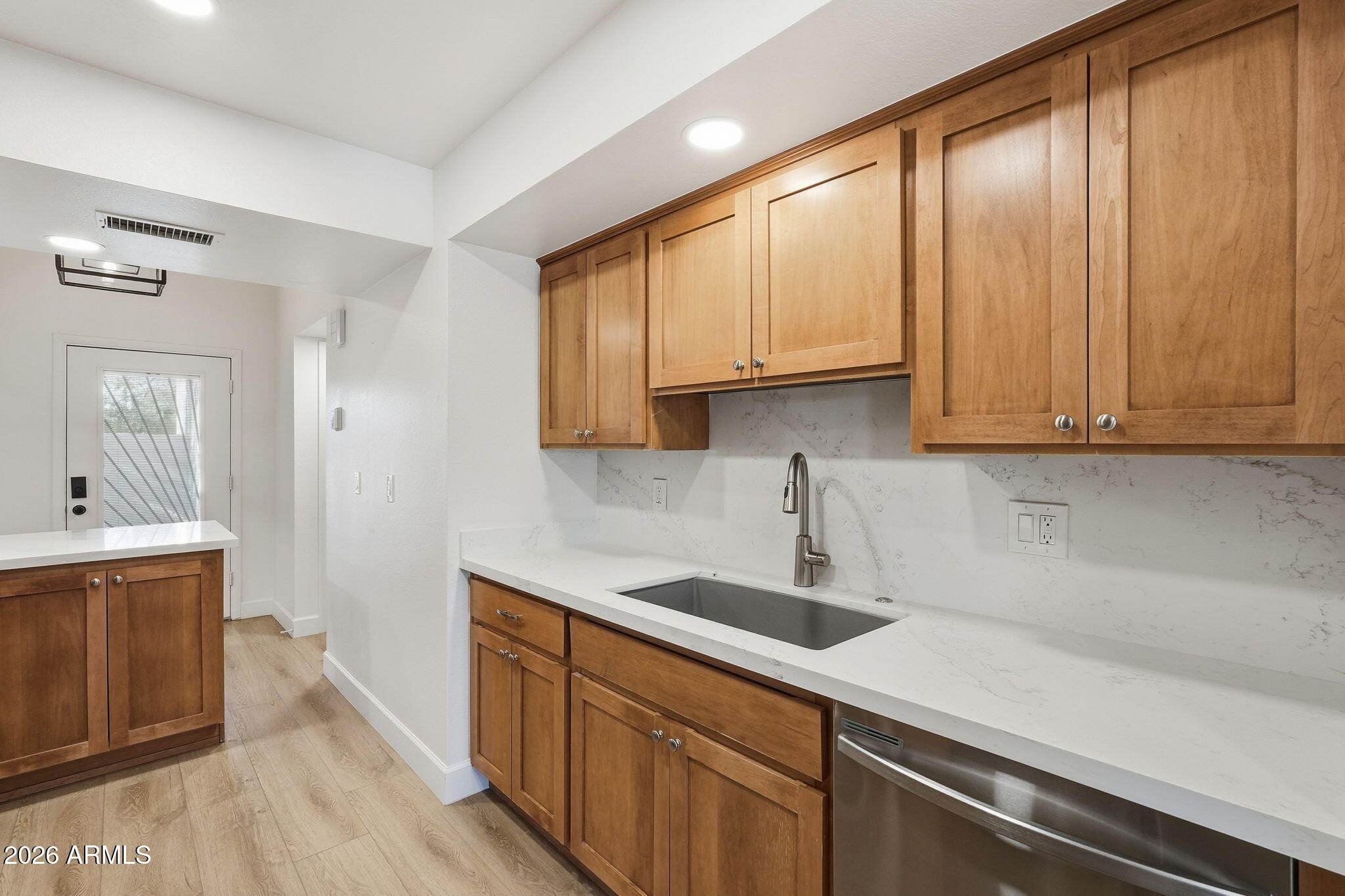 6615 East Phelps Road Scottsdale, AZ 85254 - Photo 13 of 53 a kitchen with stainless steel appliances granite countertop white cabinets a sink and dishwasher with wooden floor