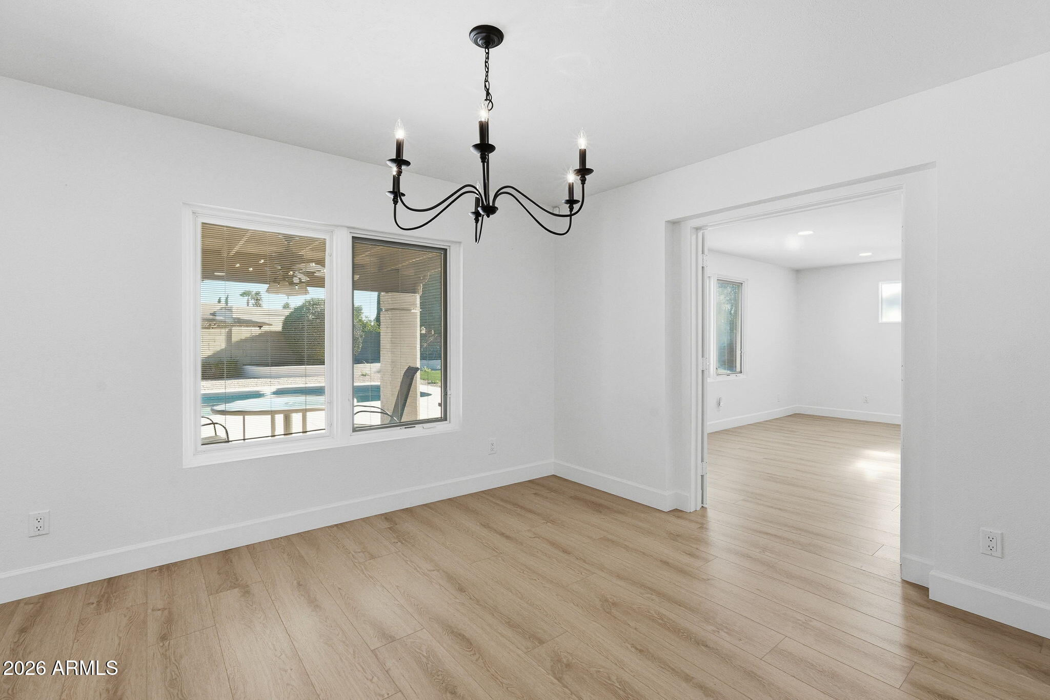 6615 East Phelps Road Scottsdale, AZ 85254 - Photo 21 of 53 a view of an empty room with wooden floor and a window