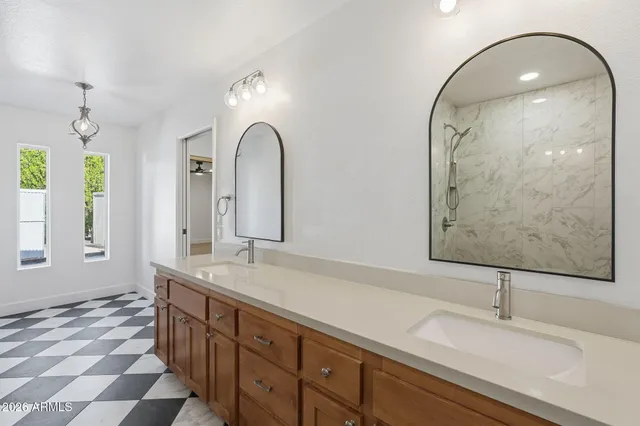a bathroom with a sink vanity granite toilet and shower