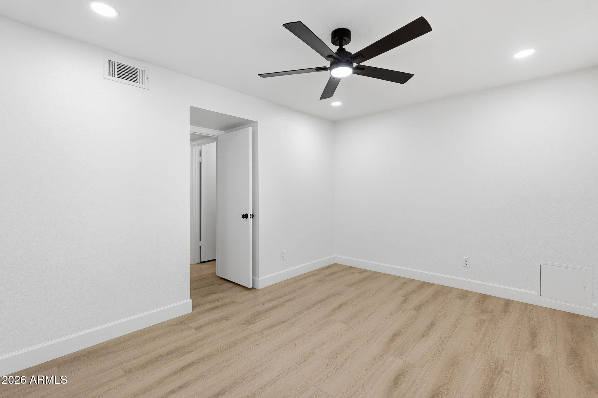 6615 East Phelps Road Scottsdale, AZ 85254 - Photo 33 of 53 an empty room with wooden floor and a ceiling fan