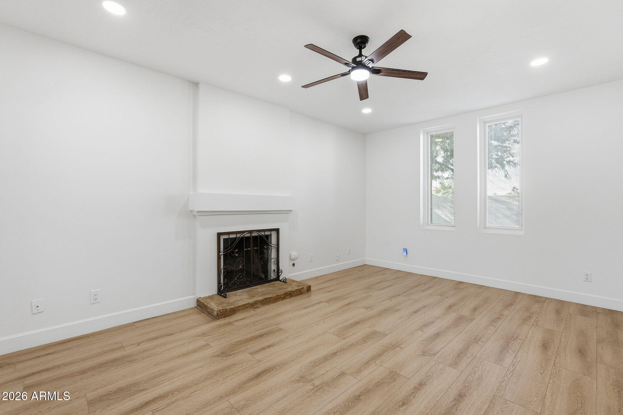 6615 East Phelps Road Scottsdale, AZ 85254 - Photo 8 of 53 an empty room with windows and fireplace