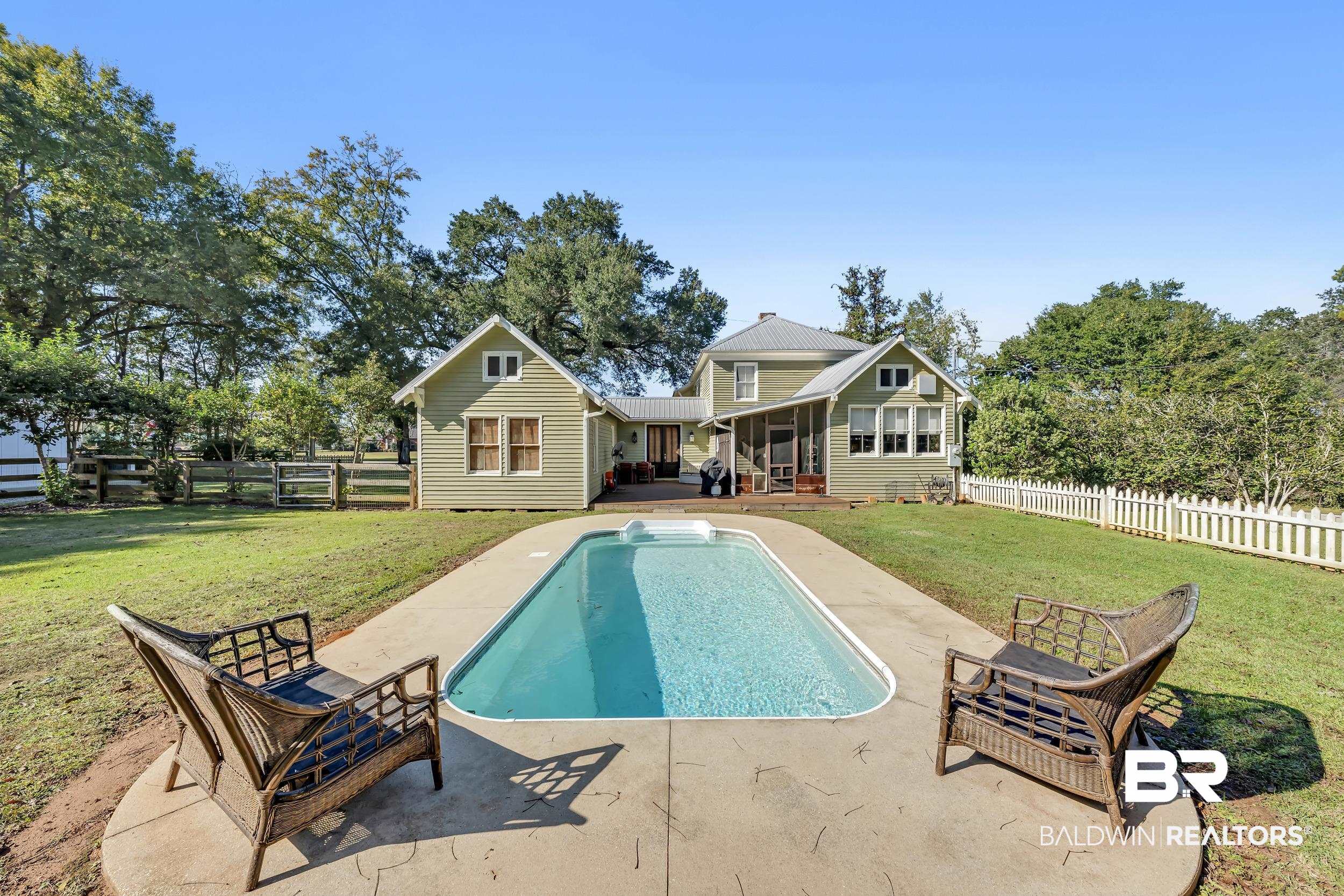13232 Mary Ann Bch Road Fairhope, AL 36532 - Photo 56 of 79 Back of house with a fenced backyard, a patio, a sunroom, and a wooden deck