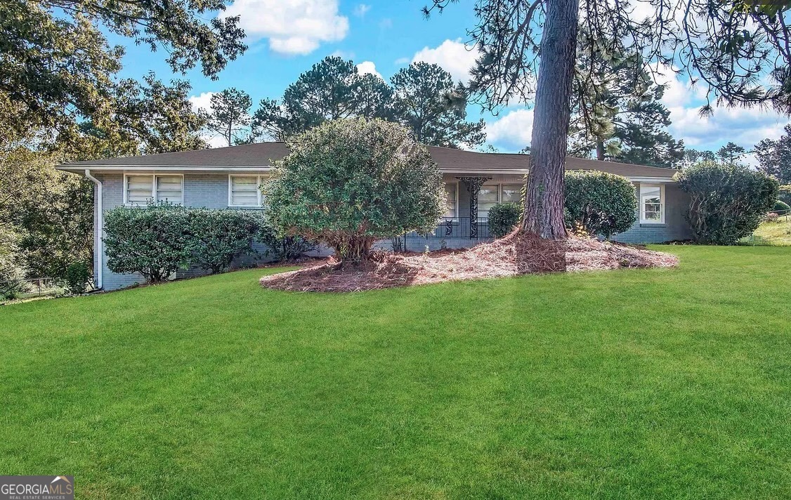 a front view of house with a garden and patio