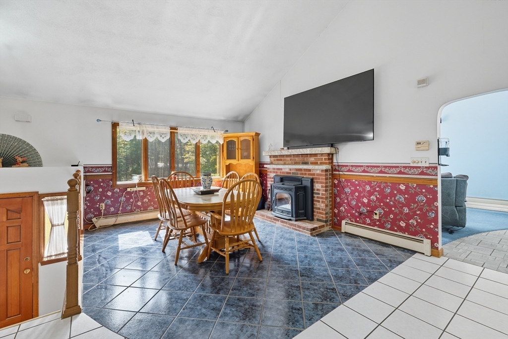 45 Red Gate Road Tyngsborough, MA 01879 - Photo 13 of 42 a dining room with furniture a rug a flat screen tv and a rug
