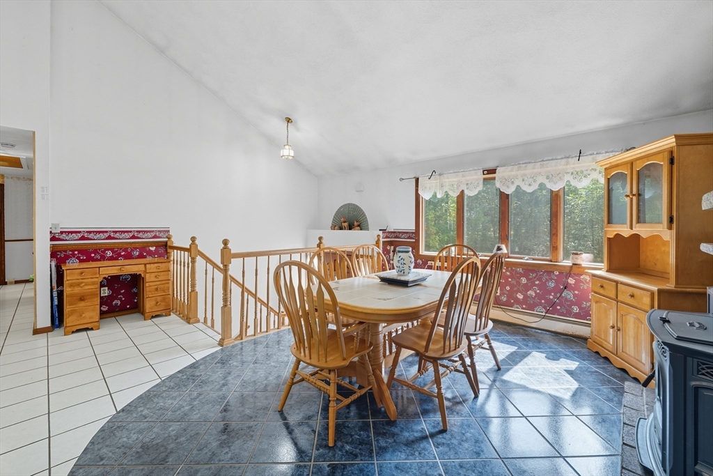45 Red Gate Road Tyngsborough, MA 01879 - Photo 14 of 42 a view of a dining room with furniture a rug and wooden floor