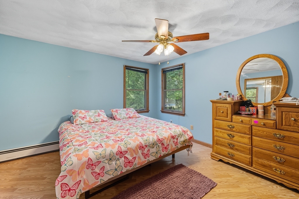 45 Red Gate Road Tyngsborough, MA 01879 - Photo 21 of 42 a bedroom with a bed and a chandelier