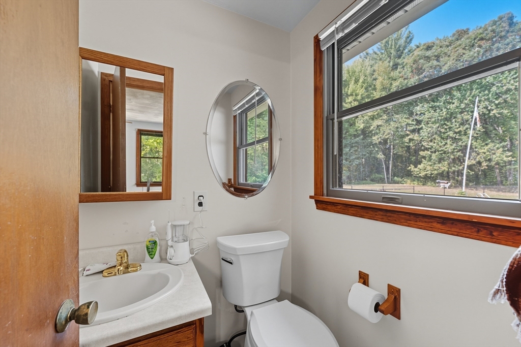 45 Red Gate Road Tyngsborough, MA 01879 - Photo 23 of 42 a bathroom with a toilet sink a mirror and window