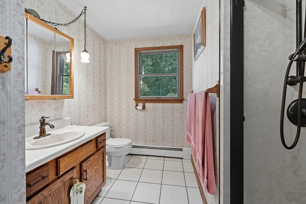 45 Red Gate Road Tyngsborough, MA 01879 - Photo 24 of 42 a bathroom with a sink a toilet and a mirror