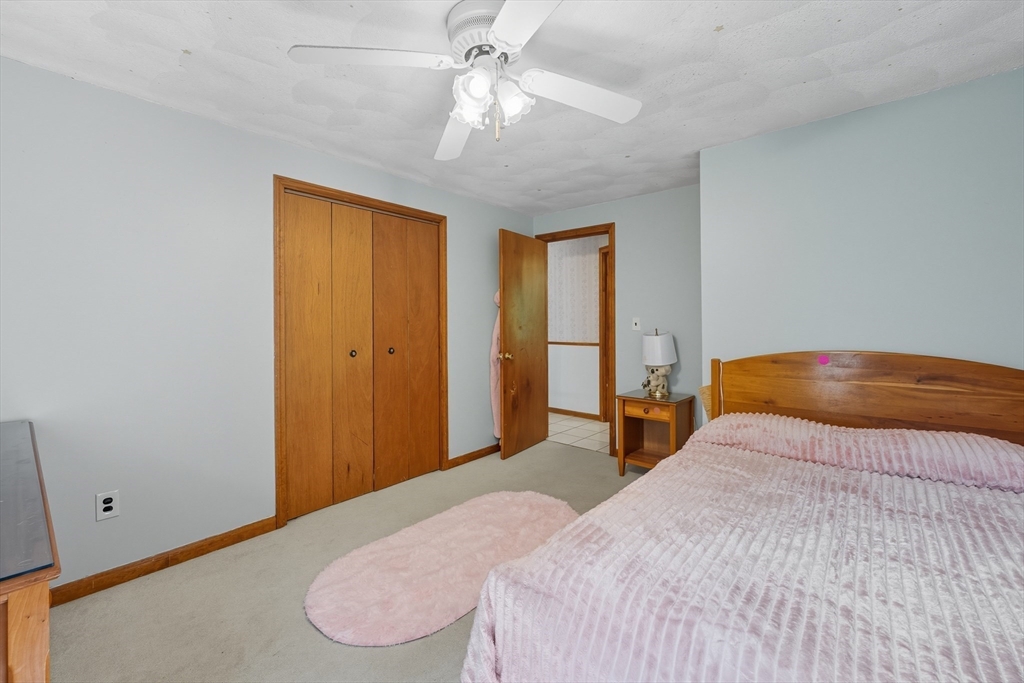 45 Red Gate Road Tyngsborough, MA 01879 - Photo 26 of 42 a bedroom with a bed and a chandelier