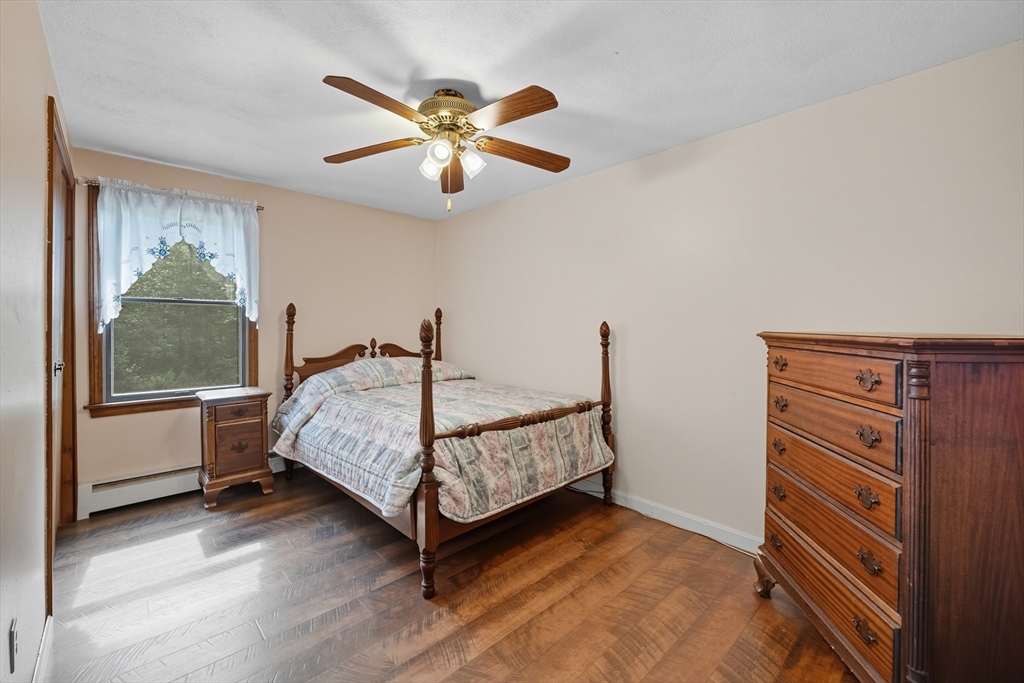 45 Red Gate Road Tyngsborough, MA 01879 - Photo 27 of 42 a bedroom with a bed and a chandelier