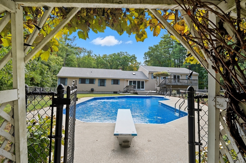 45 Red Gate Road Tyngsborough, MA 01879 - Photo 6 of 42 swimming pool view with a seating space and a garden