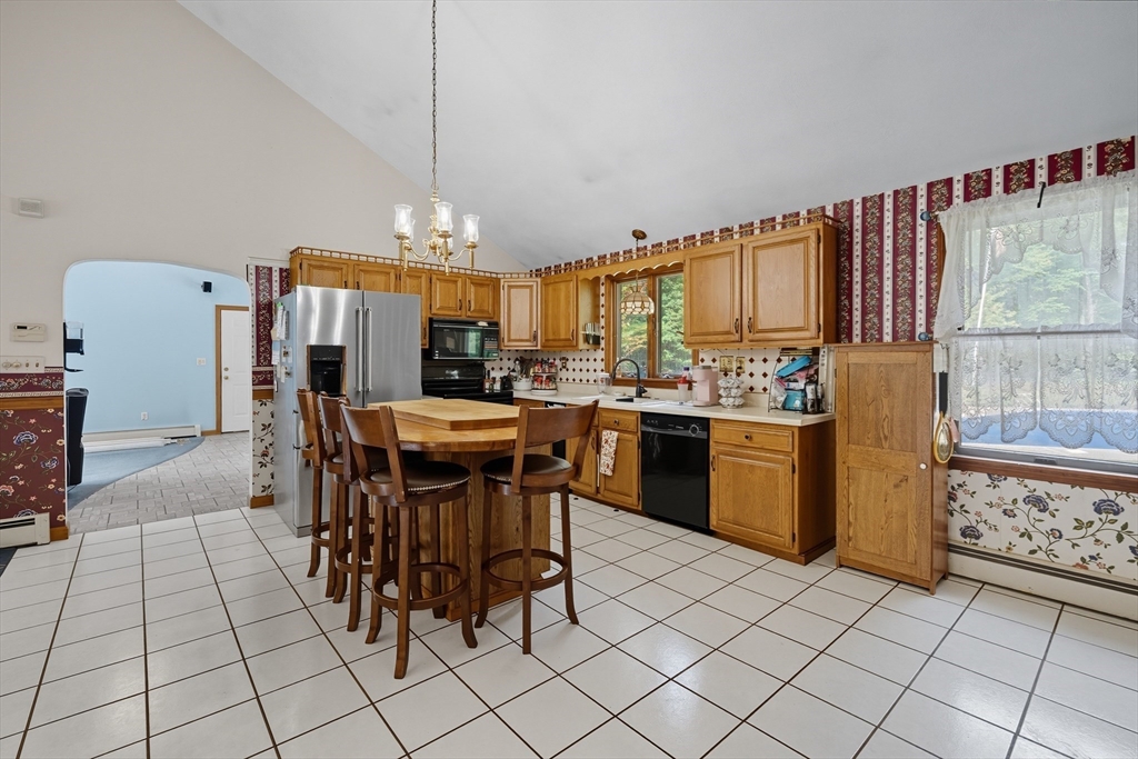 45 Red Gate Road Tyngsborough, MA 01879 - Photo 10 of 42 a kitchen with stainless steel appliances a table and chairs in it