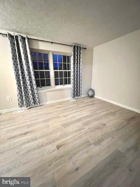 6627 Haydown Court Frederick, MD 21703 - Photo 7 of 30 a view of an empty room with wooden floor and a window