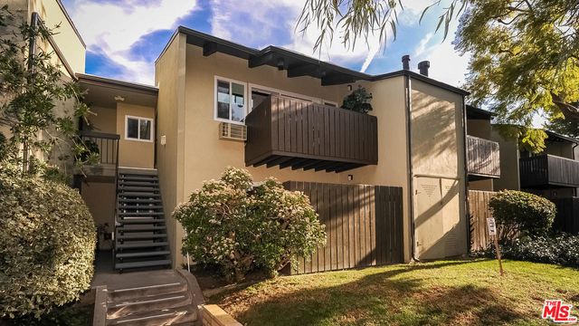 a view of a house with a tree