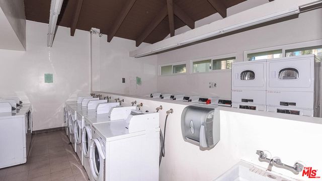 a utility room with multiple dryer and washer