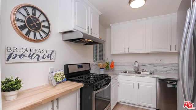 a kitchen with a stove and cabinets