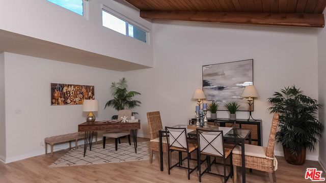 a dining room with furniture and a potted plant