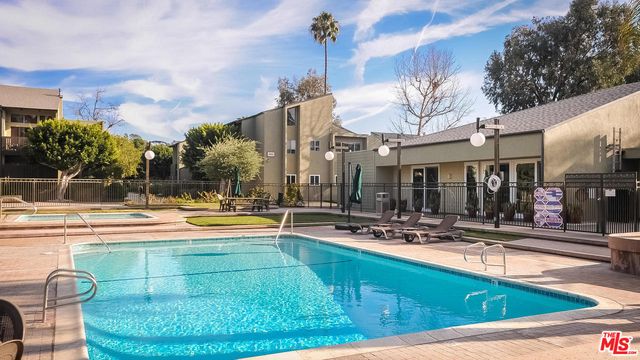 a view of a swimming pool with a lounge chairs