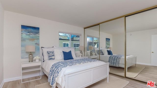 a bedroom with a bed and a mirror