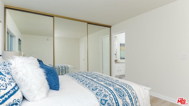 a bedroom with a bed and a mirror