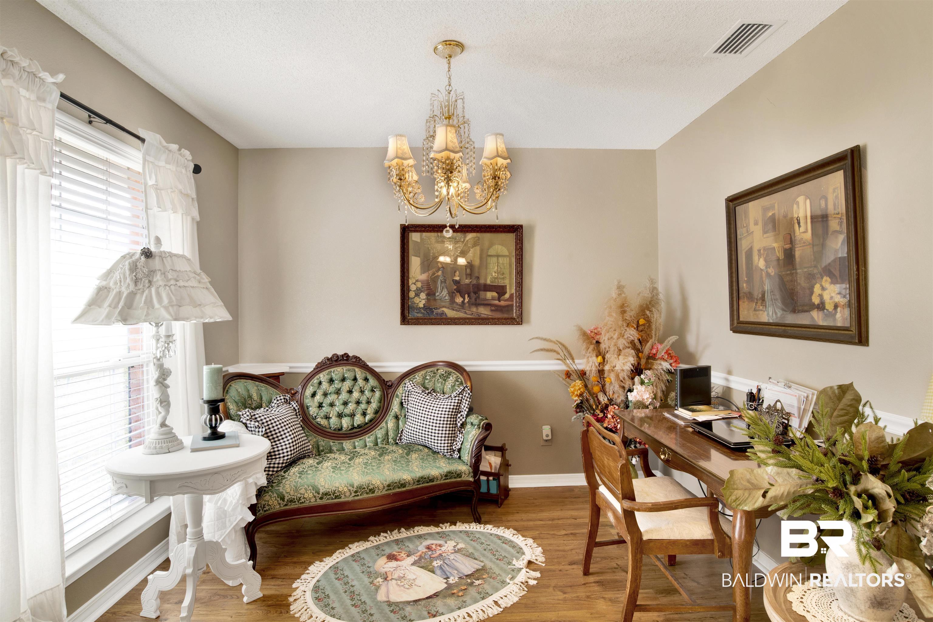 11697 Balsam Court Daphne, AL 36527 - Photo 20 of 31 Living area with hardwood / wood-style flooring and an inviting chandelier