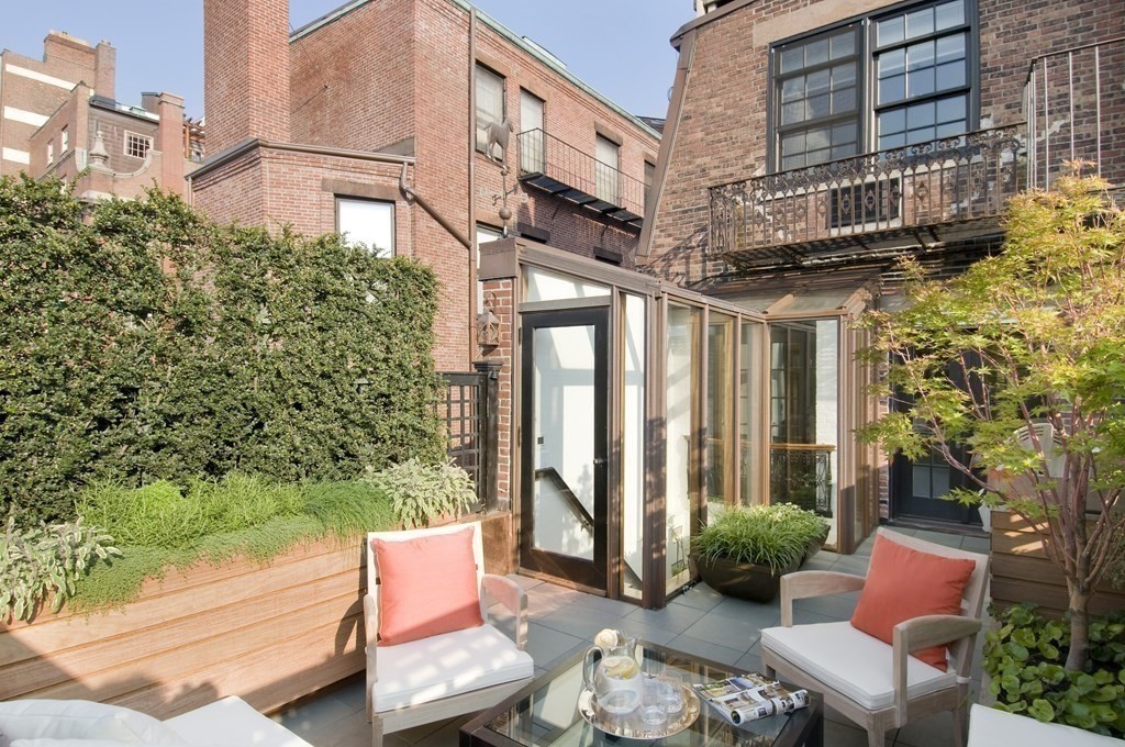88 Beacon Street, Unit 3 Boston, MA 02108 - Photo 18 of 28 a view of a patio with couches table and chairs and potted plants