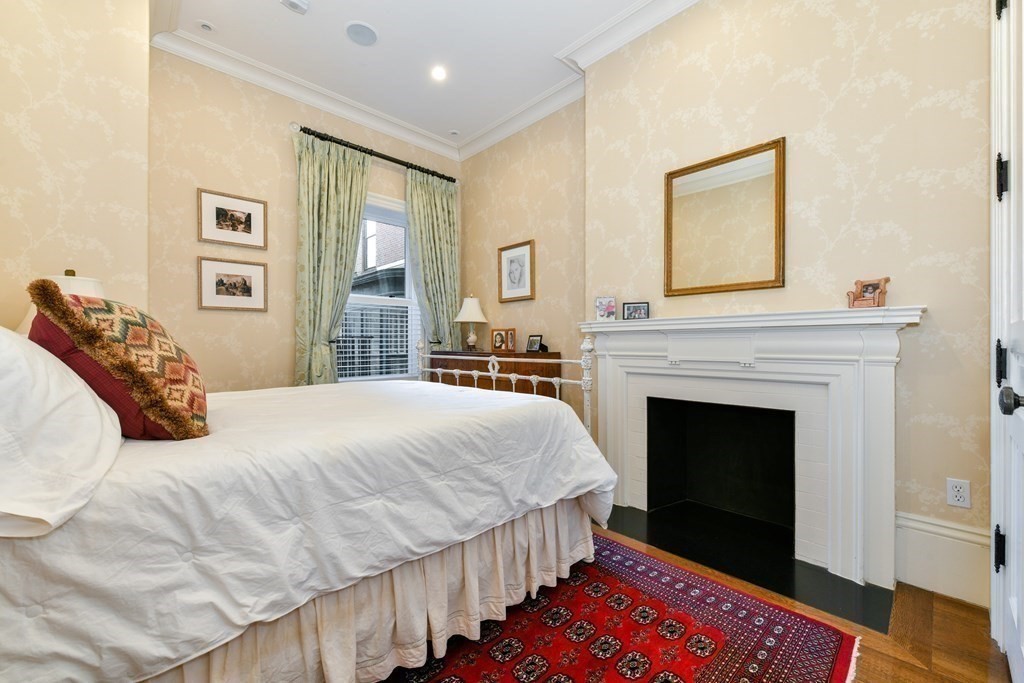 88 Beacon Street, Unit 3 Boston, MA 02108 - Photo 22 of 28 a bedroom with a bed and a fireplace