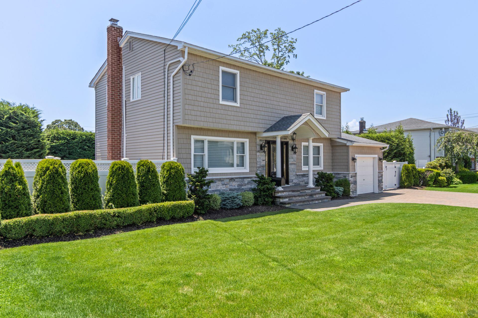 a front view of a house with a yard