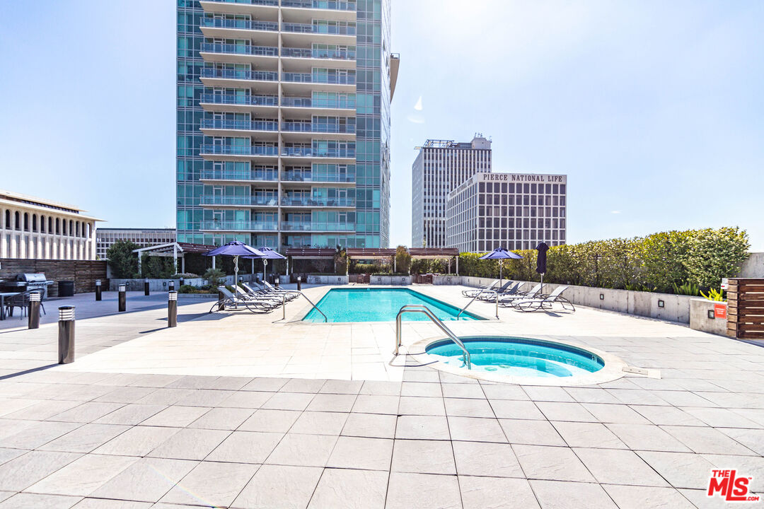 a swimming pool with outdoor seating and buildings view