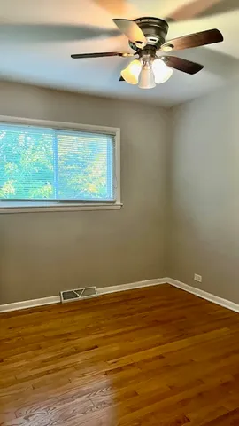 a view of a room with a window and wooden floor