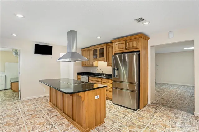 a view of a kitchen with granite countertop cabinets and a stove