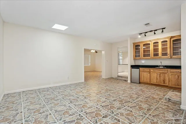 a living room with furniture and a bookshelf