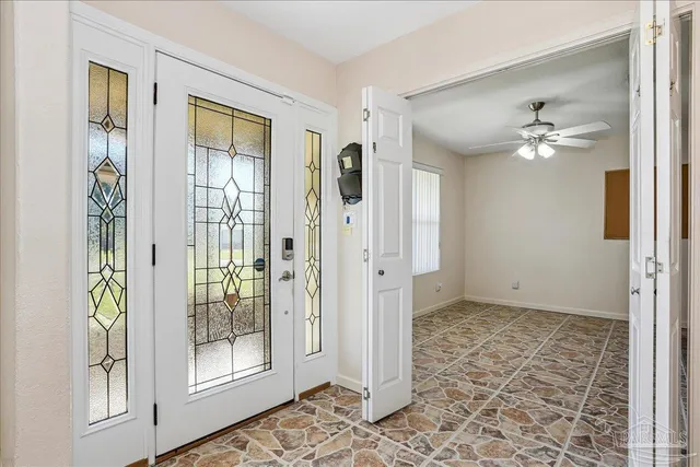 a view of an empty room with window and cabinet