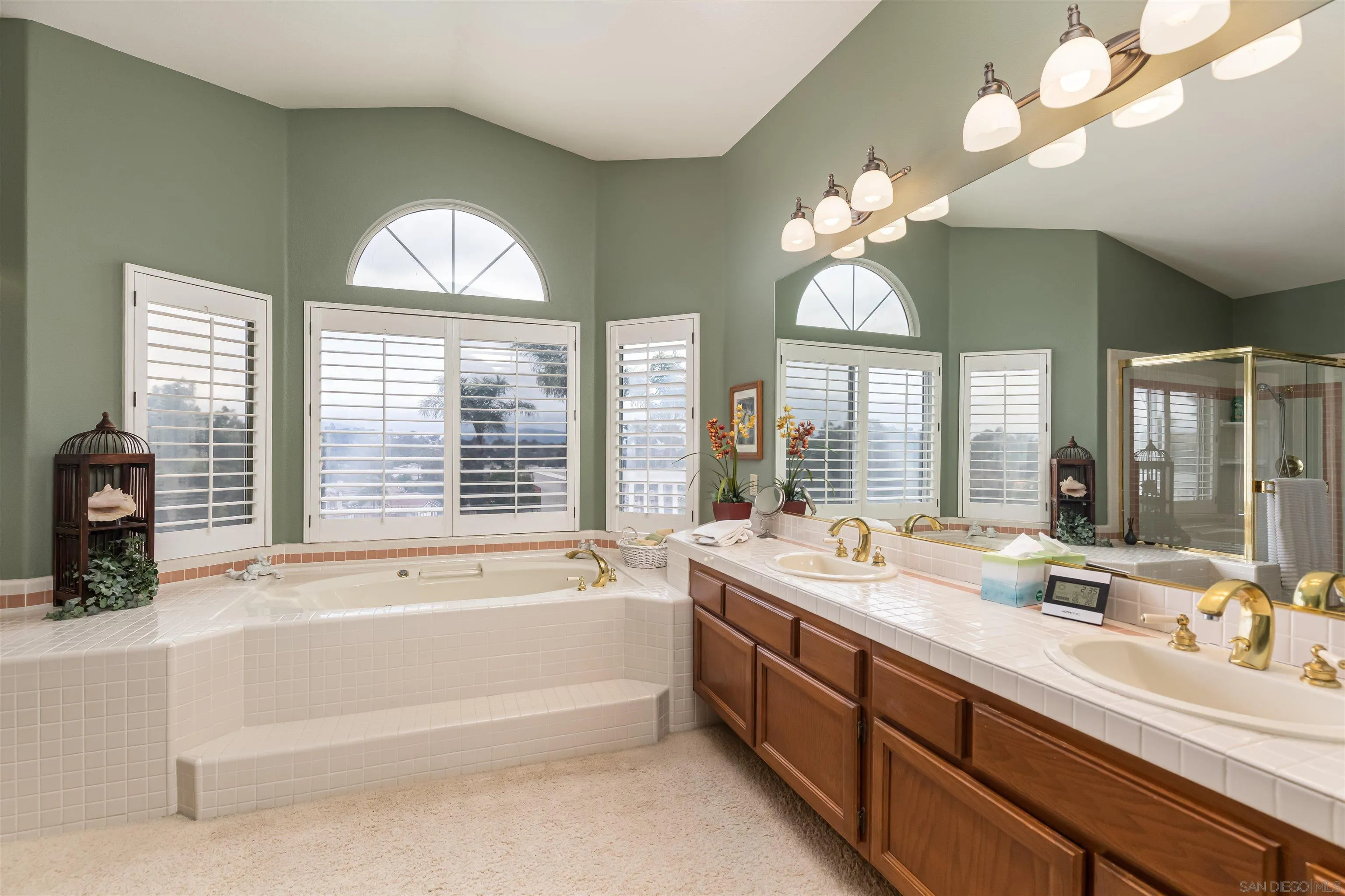 41411 Rue Jadot Temecula, CA 92591 - Photo 24 of 54 a bathroom with a tub a double vanity sink and a window