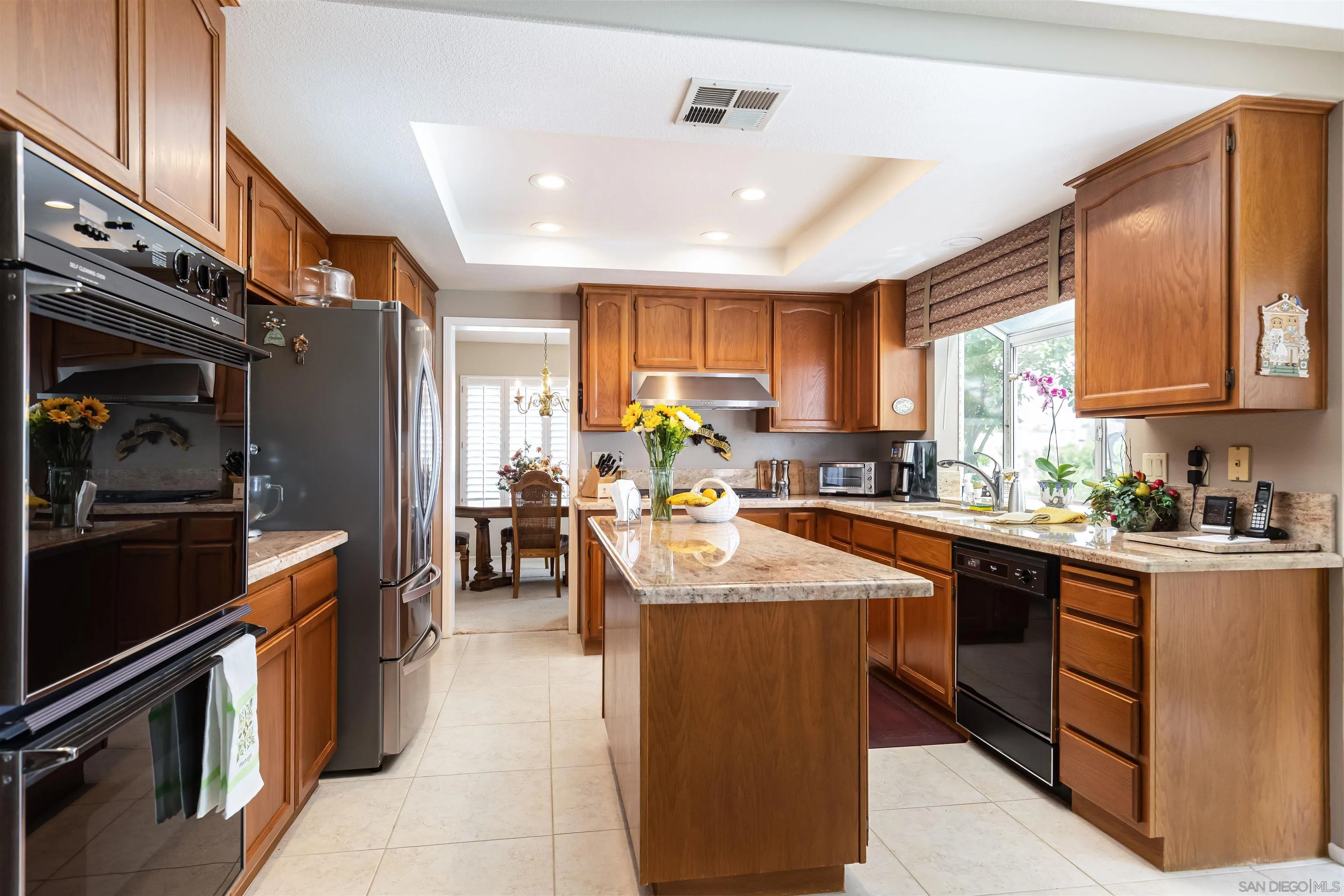 41411 Rue Jadot Temecula, CA 92591 - Photo 7 of 54 a kitchen with counter top space appliances and windows