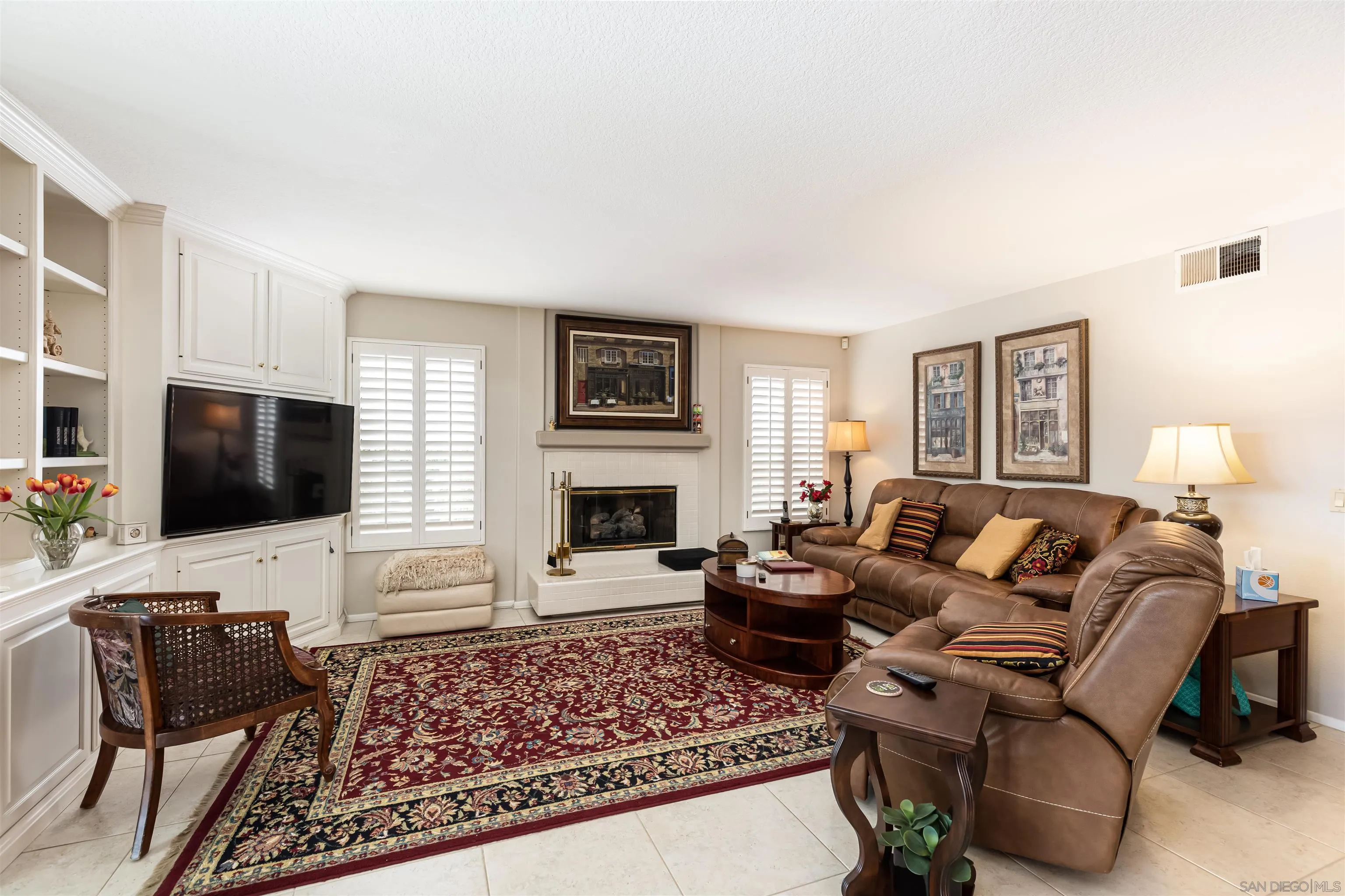 41411 Rue Jadot Temecula, CA 92591 - Photo 10 of 54 a living room with furniture a fireplace and a flat screen tv