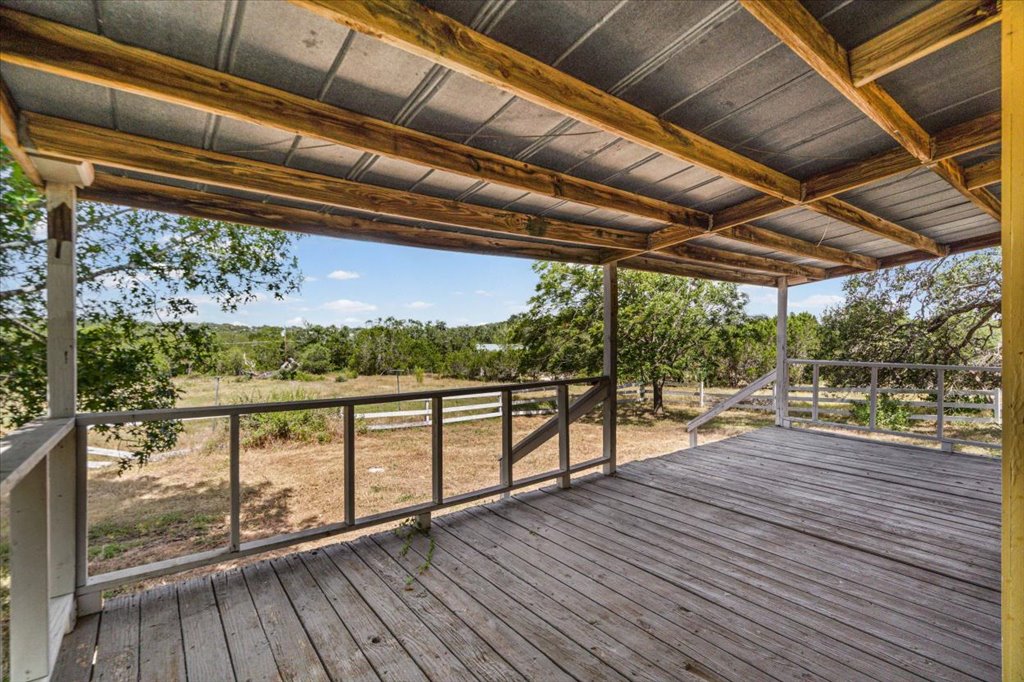 13501 Nutty Brown Road, Unit B Austin, TX 78737 - Photo 23 of 29 A spacious covered deck extends to embrace the serene natural landscape.