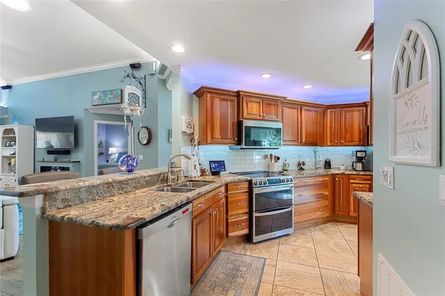 a kitchen with a refrigerator and a stove top oven