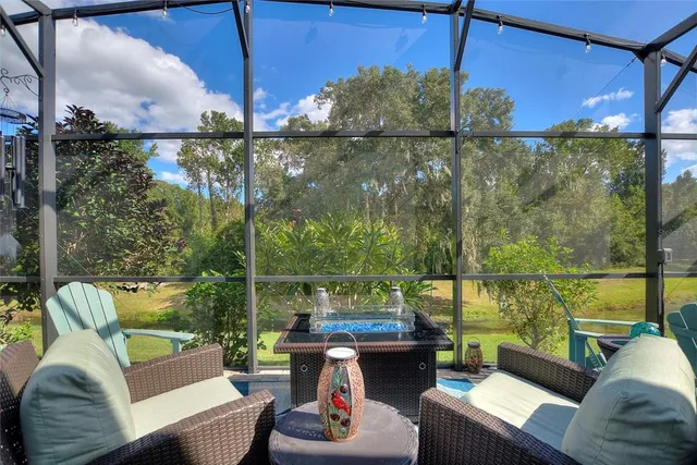 a outdoor living room with patio furniture and a potted plant