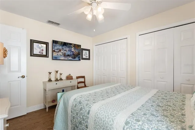 a bathroom with a granite countertop sink a toilet and a mirror
