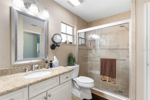 a bedroom with a bed and a mirror