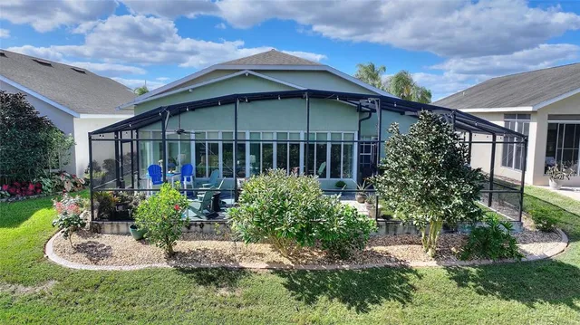 an aerial view of a house with garden space and street view