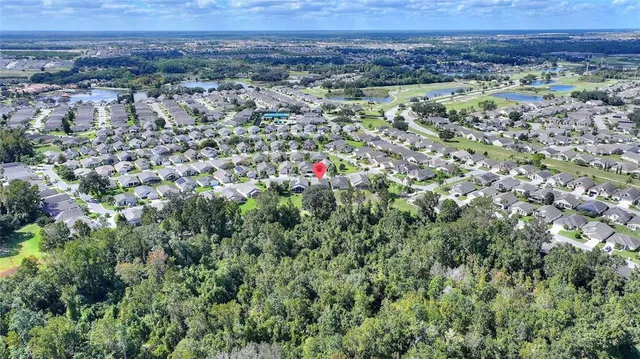 an aerial view of a house with a yard and lake view