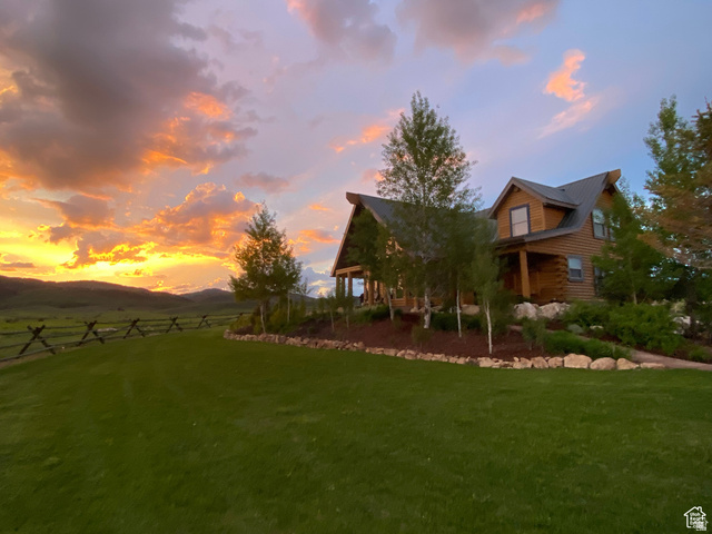 79 Auburn Forest Road Auburn, WY 83111 - Photo 3 of 76 Yard at dusk featuring a mountain view and covered porch
